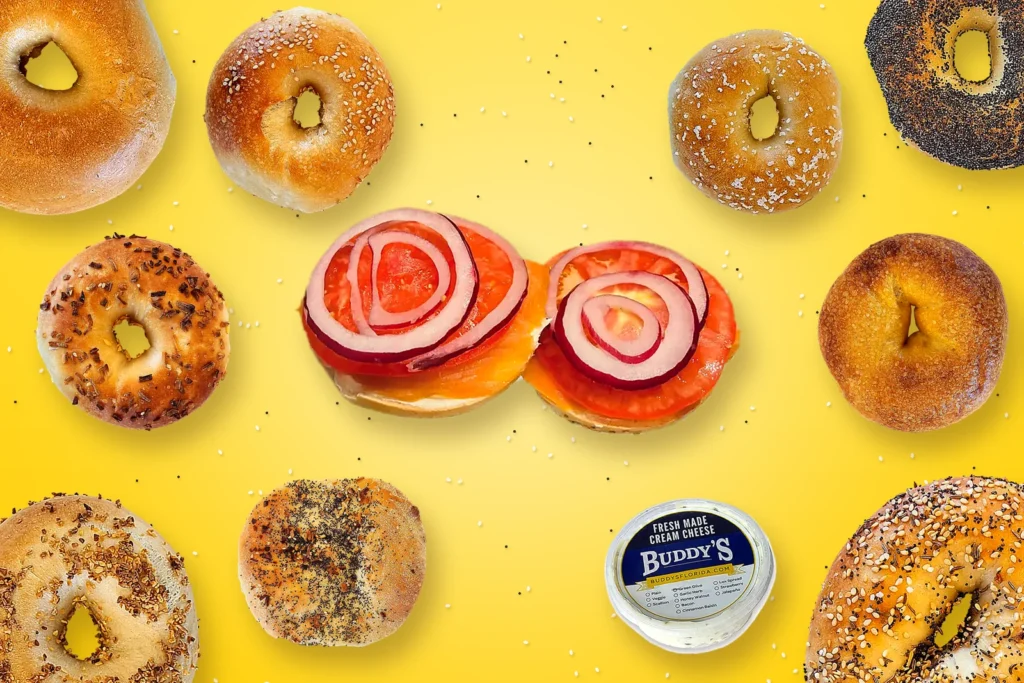 New York-style bagels from Buddy’s Bagels, including plain, sesame, poppy, everything, and a bialy, around a smoked salmon bagel with tomato and red onion